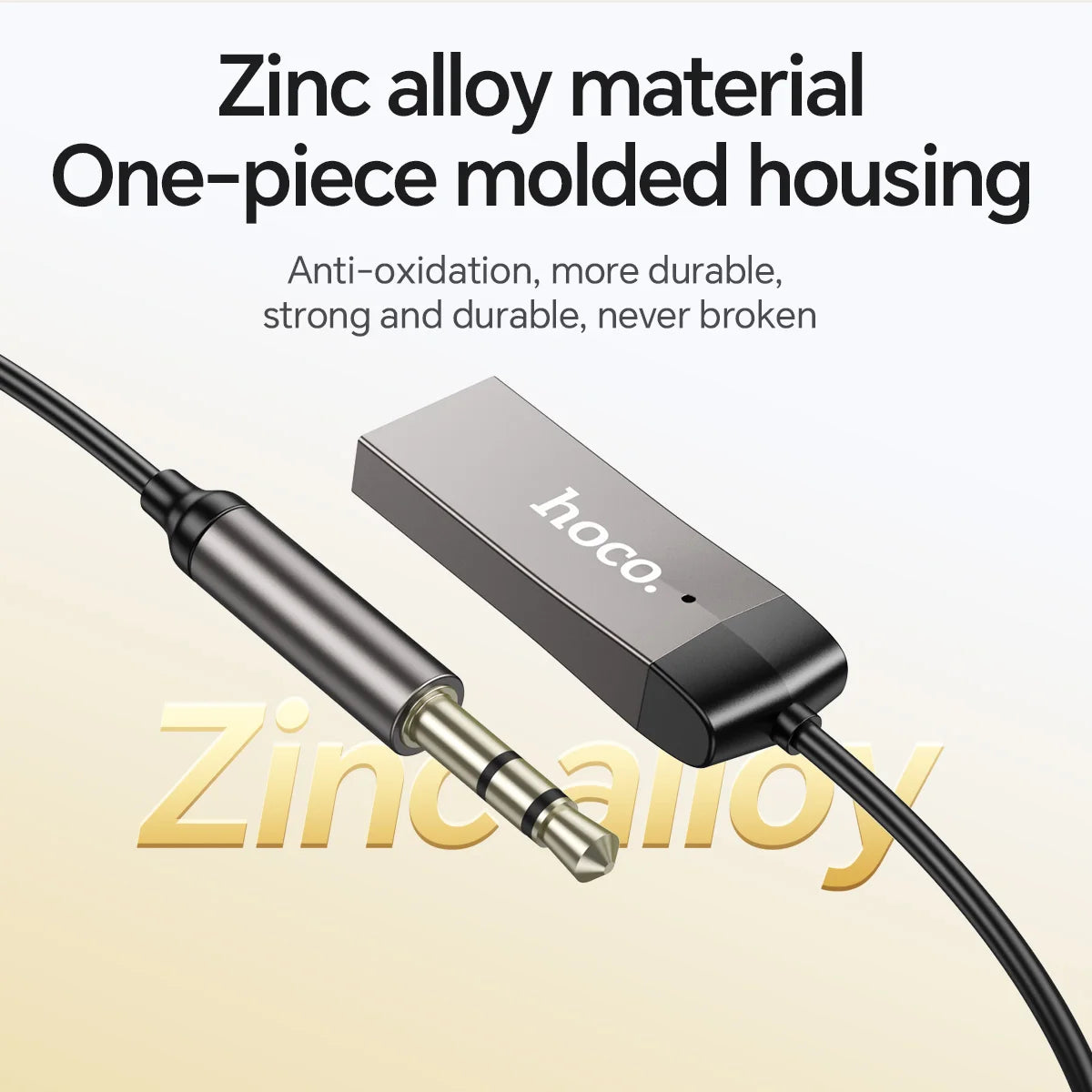 Hoco audio adapter with text highlighting zinc alloy material and one-piece molded housing on a beige background.