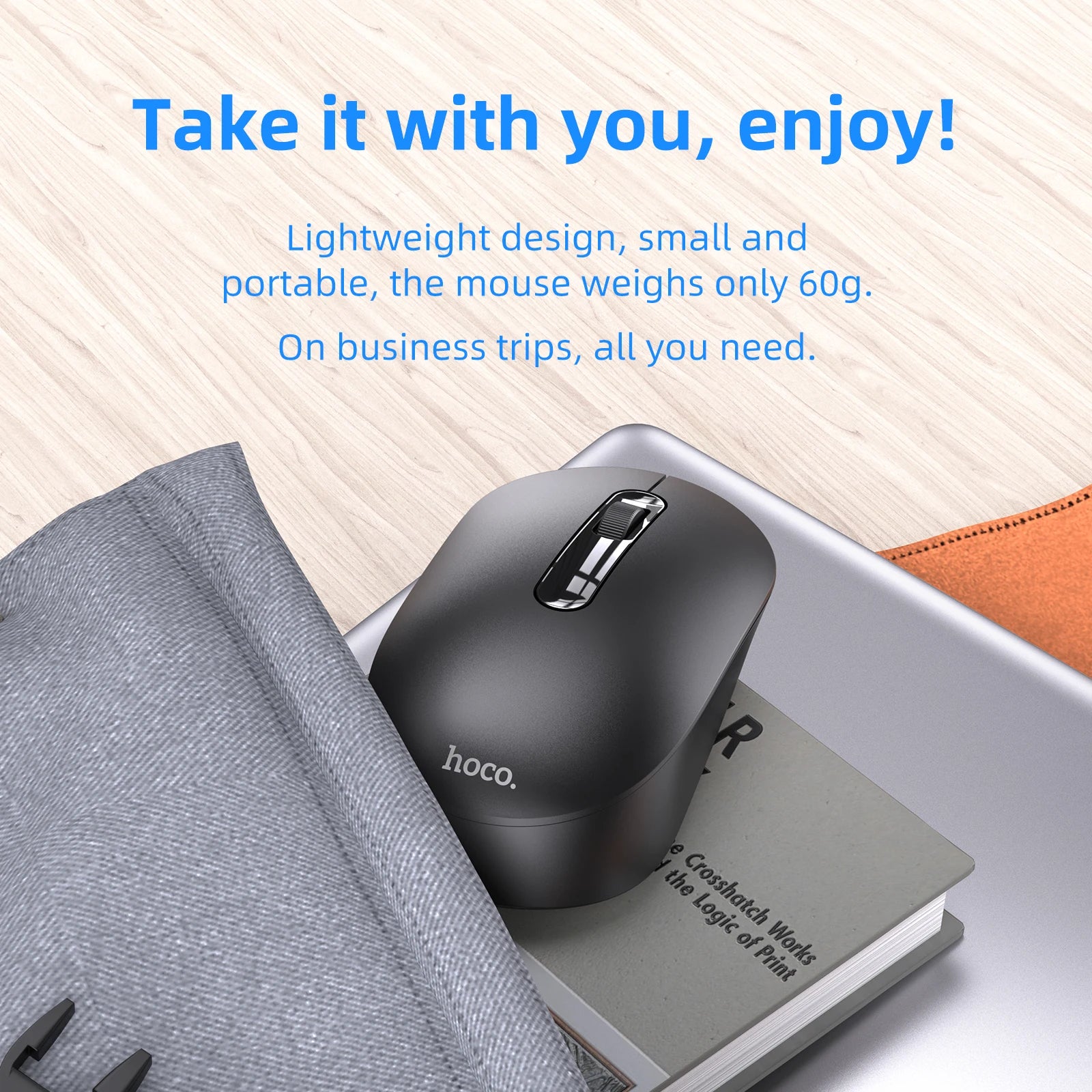 Black computer mouse on a book with text about its lightweight design and portability.
