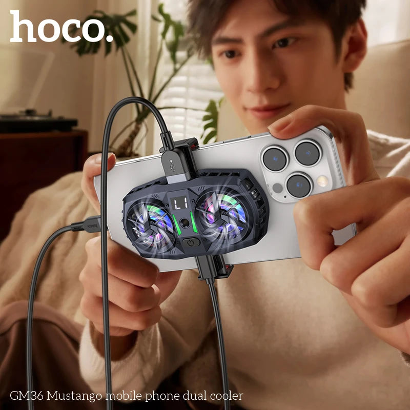Person holding a smartphone with a dual cooler attachment, branded 'hoco'.