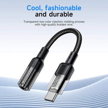Black USB cable with braided design on a light blue background