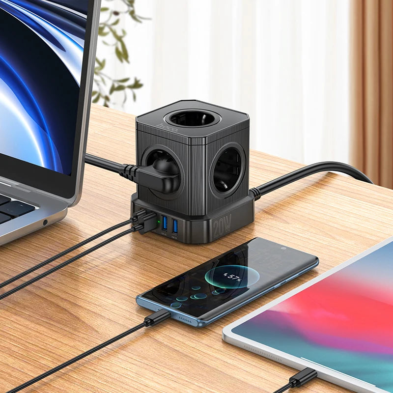 Multifunctional power adapter with multiple ports on a desk with electronic devices.