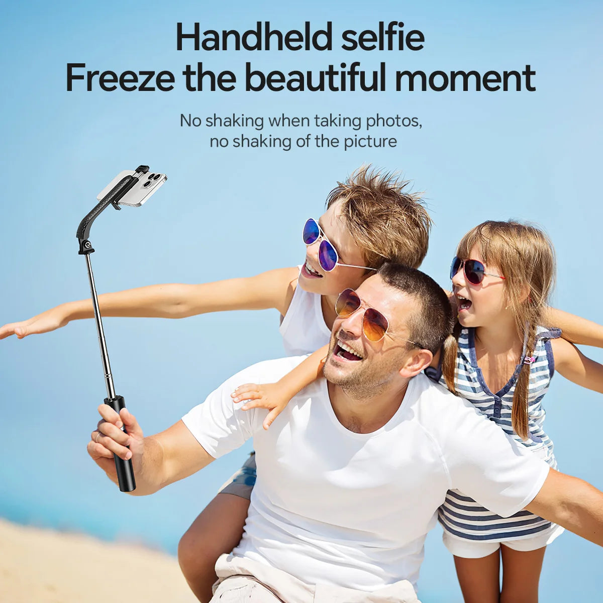 Family using a handheld selfie stick with a clear blue sky background