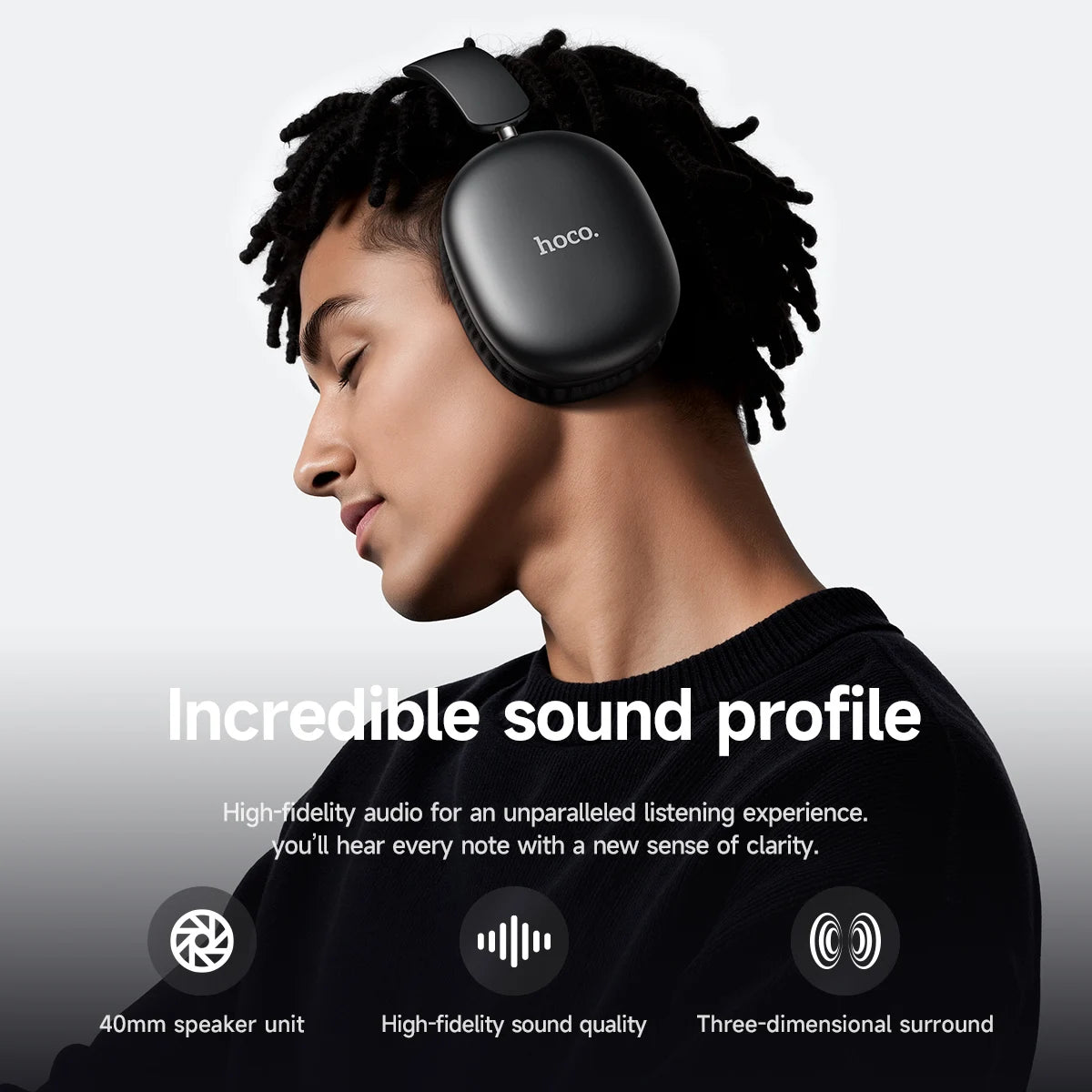 Person wearing black headphones with 'hoco' branding, set against a gray background.