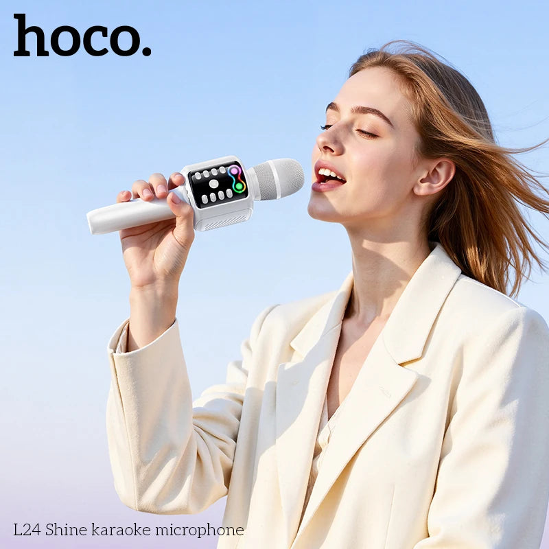 Woman holding a hoco L24 Shine karaoke microphone against a clear blue sky