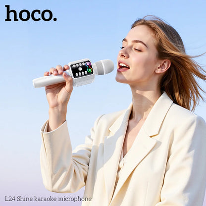 Woman holding a hoco L24 Shine karaoke microphone against a clear blue sky