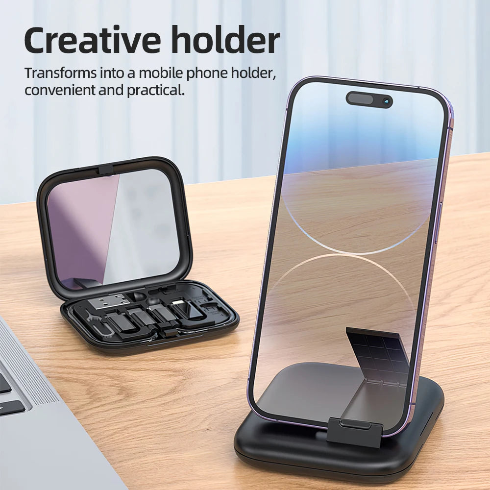 Black creative holder transforming into a phone stand on a wooden surface with text.