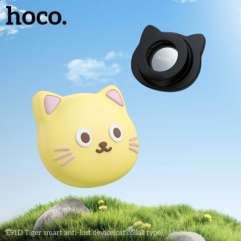 Cat-shaped device and black cat-shaped collar with 'hoco.' branding against a blue sky and grass background.
