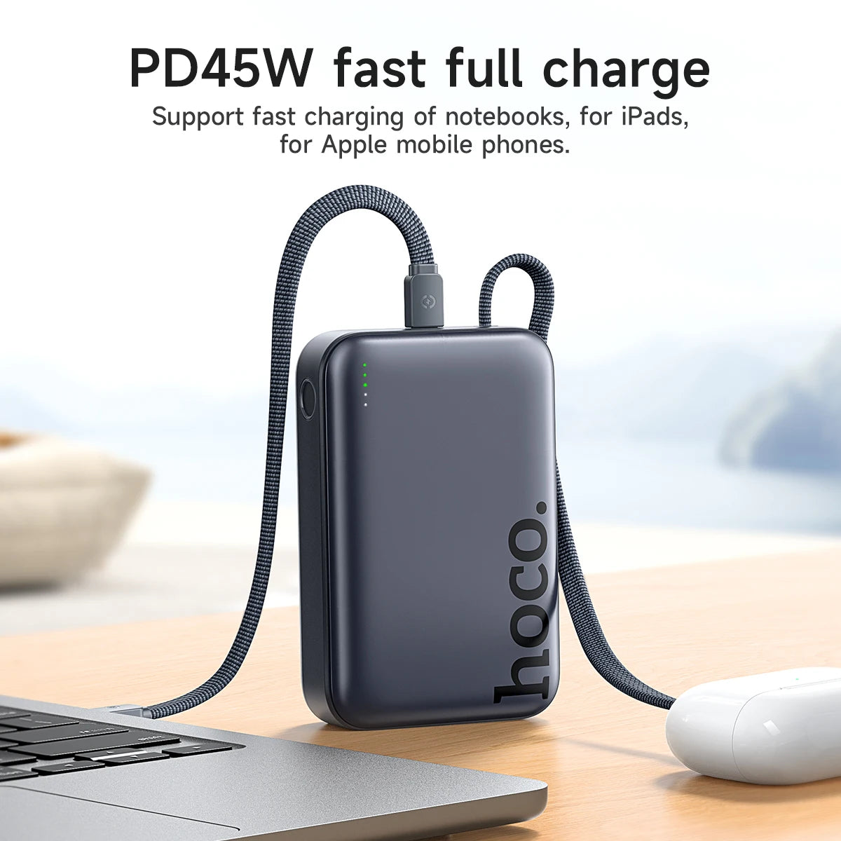 Hoco power bank with cable on a desk next to a laptop and mouse, with text about fast charging capabilities.