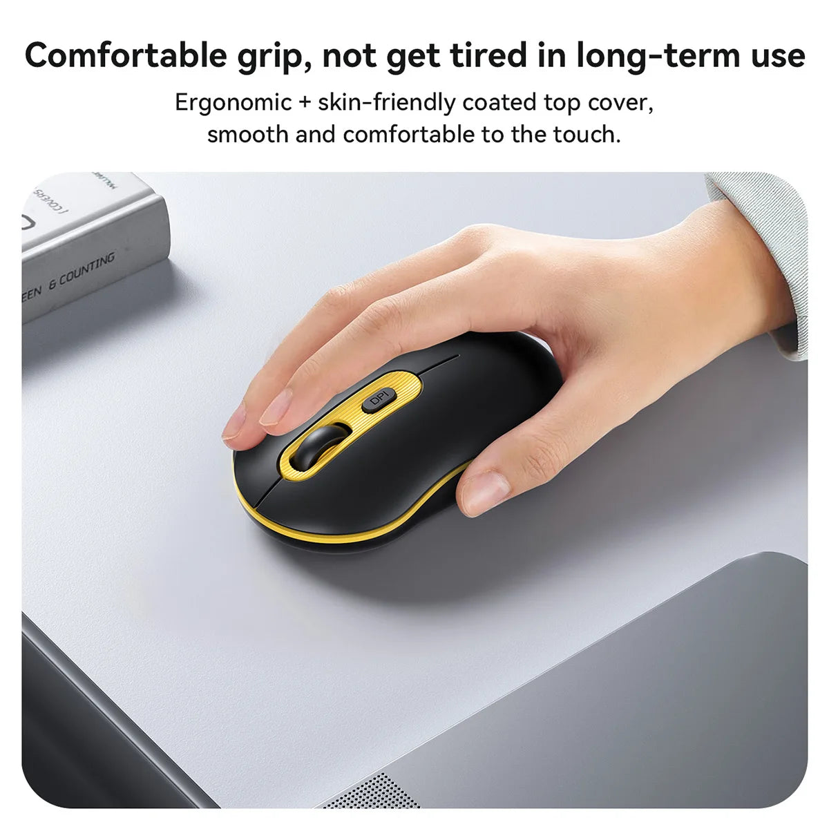 Hand using a black and yellow computer mouse on a desk with text about comfort and ergonomics.