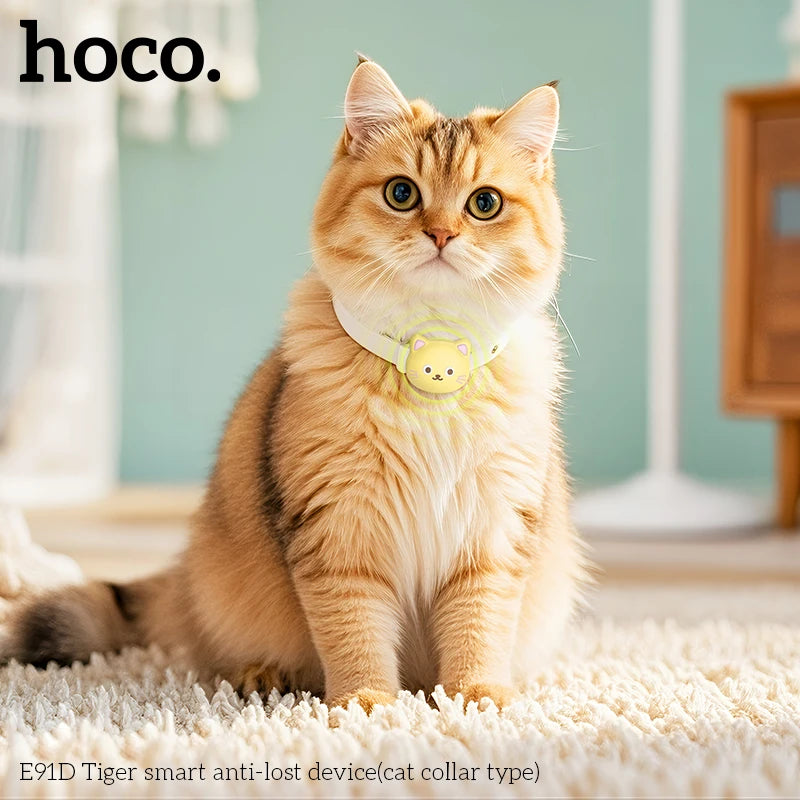 Cat wearing a yellow collar with a 'hoco.' device on a light-colored carpet.