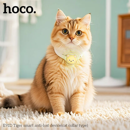 Cat wearing a yellow collar with a 'hoco.' device on a light-colored carpet.