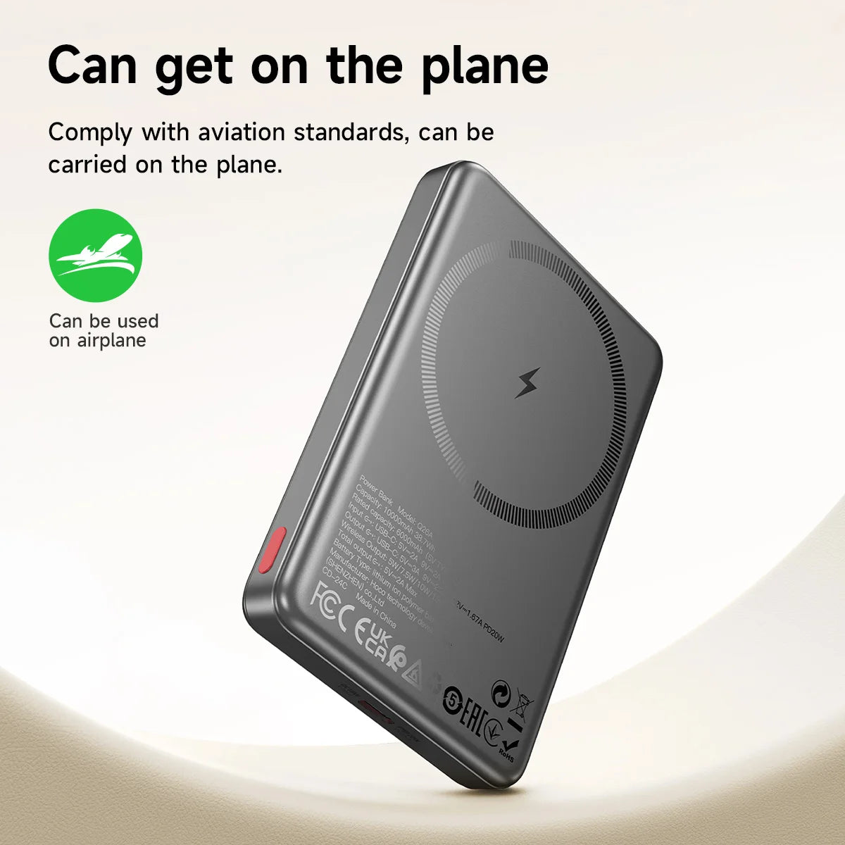 Black wireless charging pad with aviation compliance label on a light background