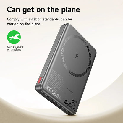 Black wireless charging pad with aviation compliance label on a light background