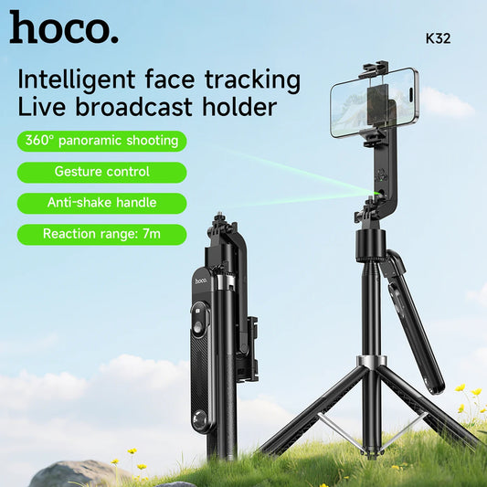 Hoco K32 intelligent face tracking live broadcast holder with 360-degree panoramic shooting and gesture control on a grassy background.