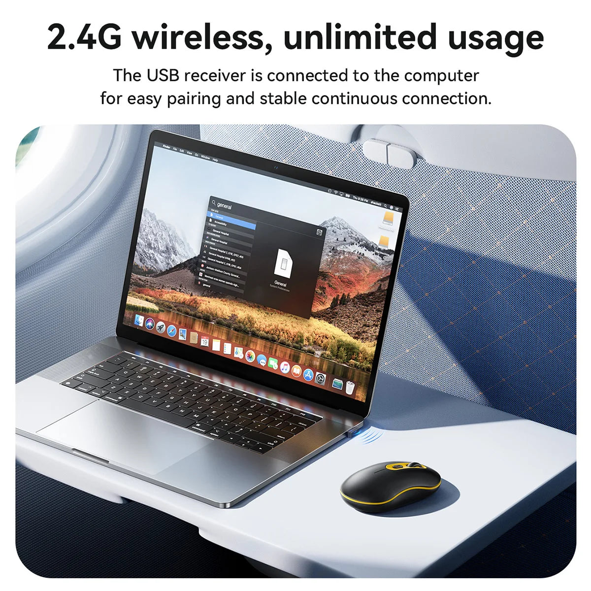 Laptop on a tray table with a USB receiver, connected to a computer, on an airplane seat.